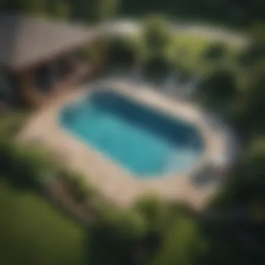 Comprehensive Landscape Design An aerial view showcasing a well-designed layout of an above ground pool with surrounding landscape features.