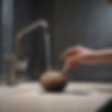 Using a Plunger Effectively Plunger being used to clear a sink blockage